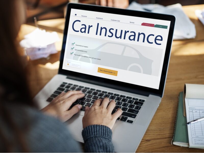 Photo-of-car-insurance-coverage-being-purchased-by-a-woman-using-a-laptop-computer