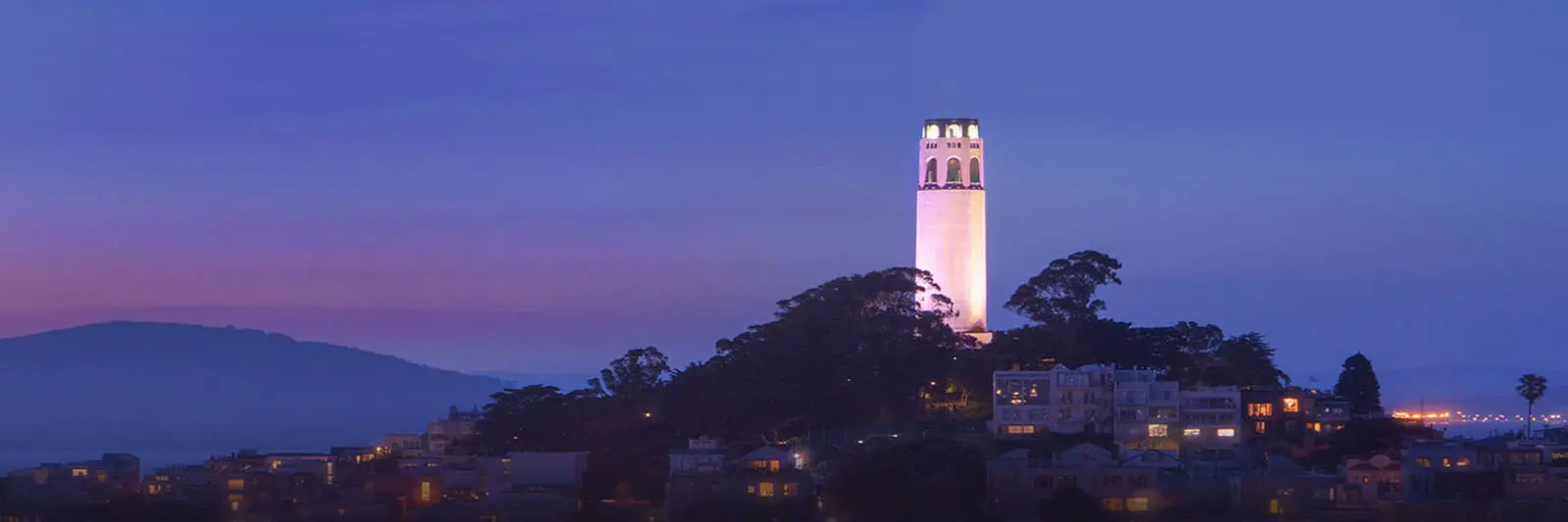 San Francisco Personal Injury Lawyers and Accident Attorneys View of Downtown San Francisco, California and Coit Tower at Night