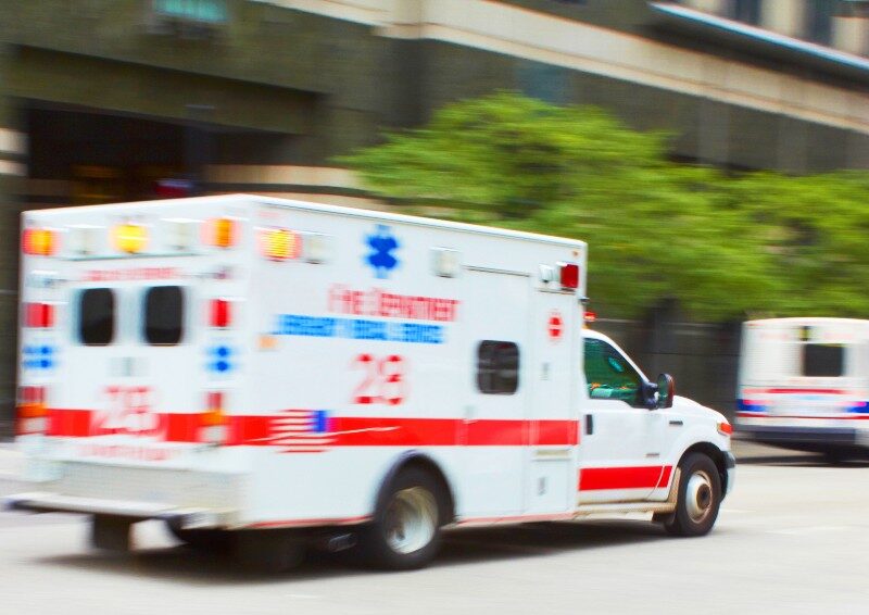 Photo of an ambulance driving on a city street