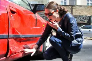 San Francisco Hit adn Run Accident woman looking at her car