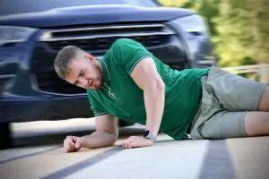 photo of a young man on the ground after being hit by a car in a crosswalk