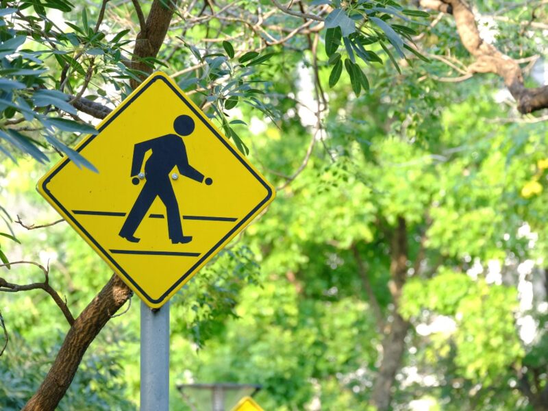 street sign indicating pedestrians in the area