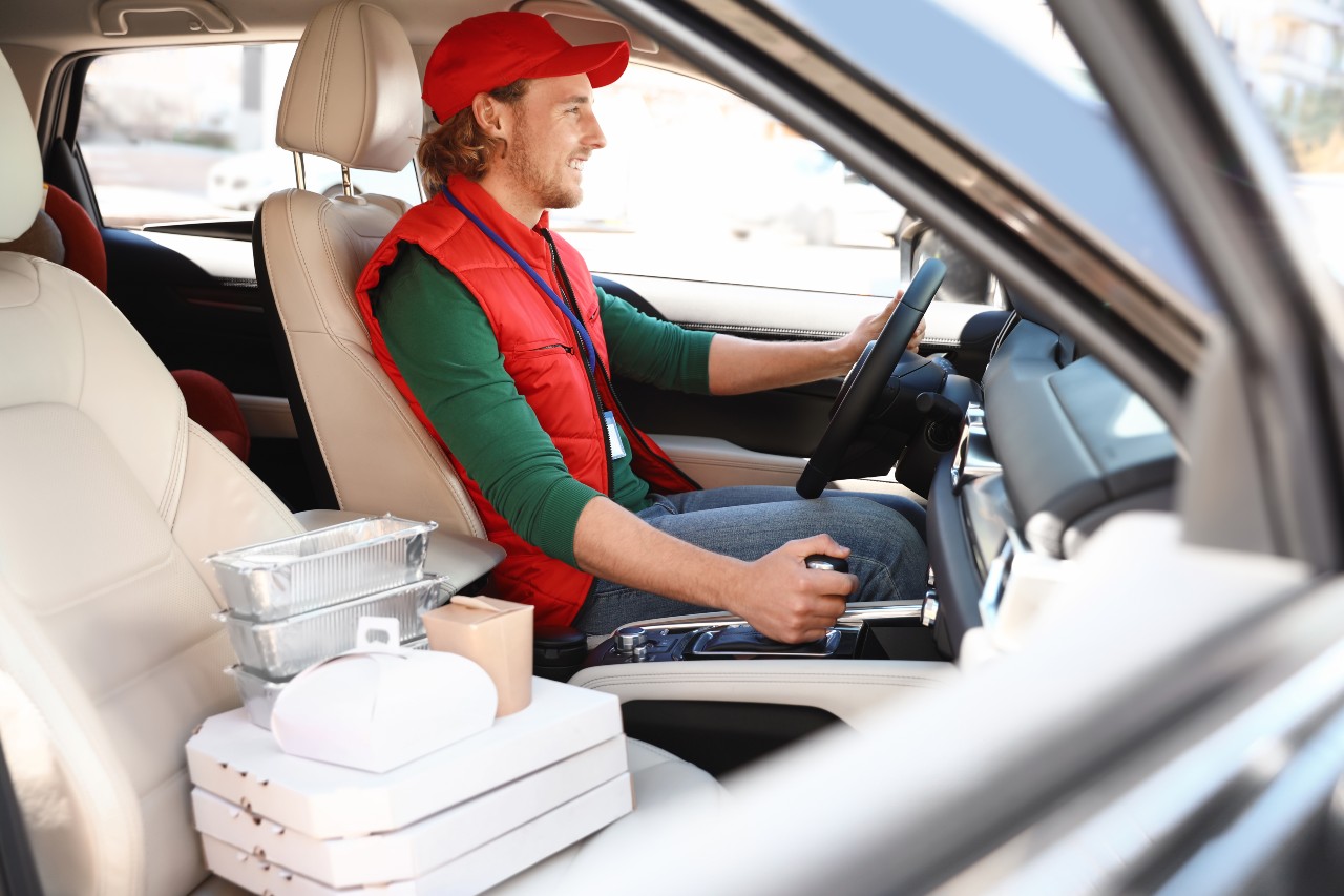 Door dash driver in his vehicle delivering a food order