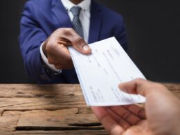 photo of a man receiving a car accident settlement check