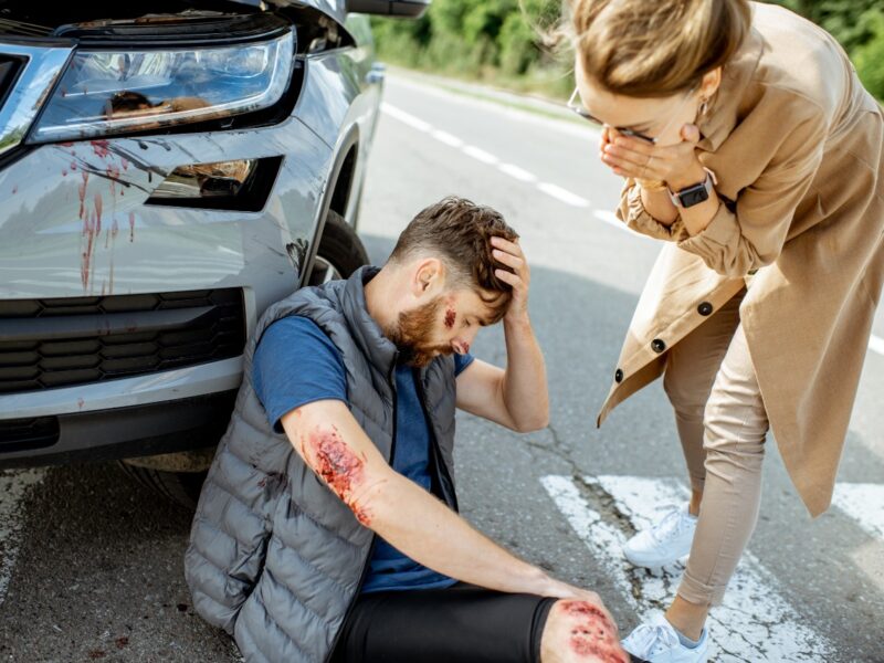 photo of a pedestrian on the ground after being hit by a car