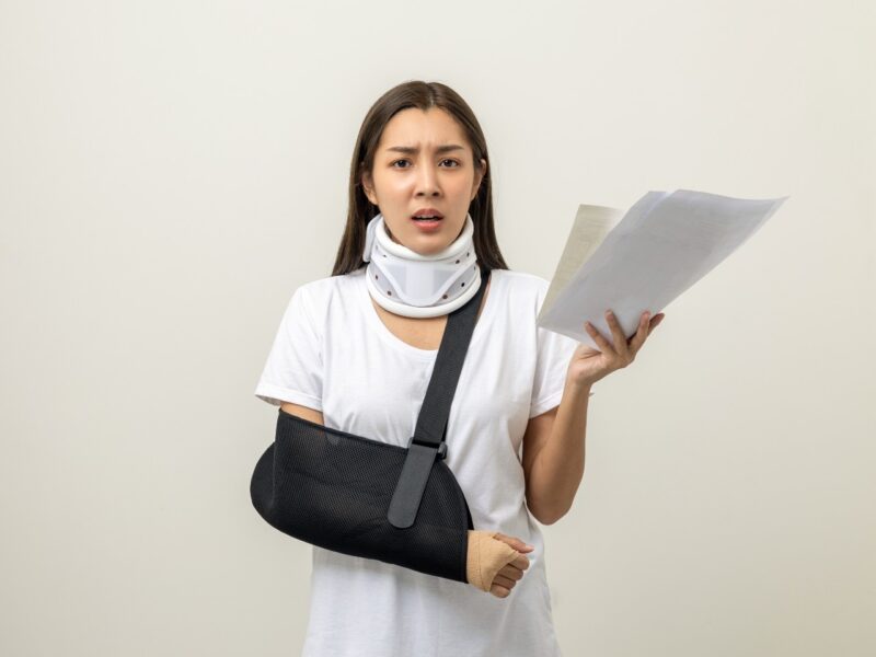 injured woman holding medical bills