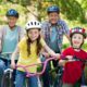 Photo of a family riding bicycles wearing helmets